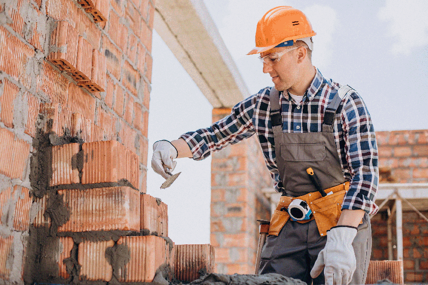 Picture of a young man pointing a wall