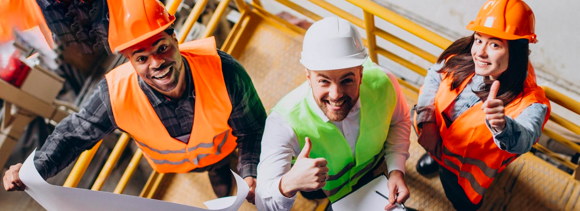 3 people working in a construction site looking at plans viewed from above
